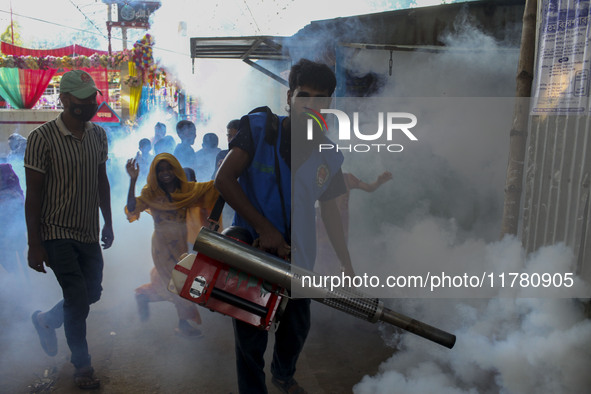 A worker sprays pesticide to kill mosquitoes at a slum in the capital city of Dhaka, Bangladesh. The country records 1,705 dengue-related de...