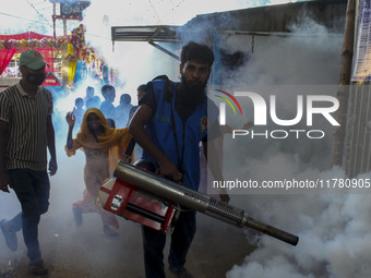 A worker sprays pesticide to kill mosquitoes at a slum in the capital city of Dhaka, Bangladesh. The country records 1,705 dengue-related de...