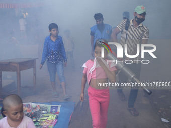 A worker sprays pesticide to kill mosquitoes at a slum in the capital city of Dhaka, Bangladesh. The country records 1,705 dengue-related de...