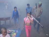 A worker sprays pesticide to kill mosquitoes at a slum in the capital city of Dhaka, Bangladesh. The country records 1,705 dengue-related de...