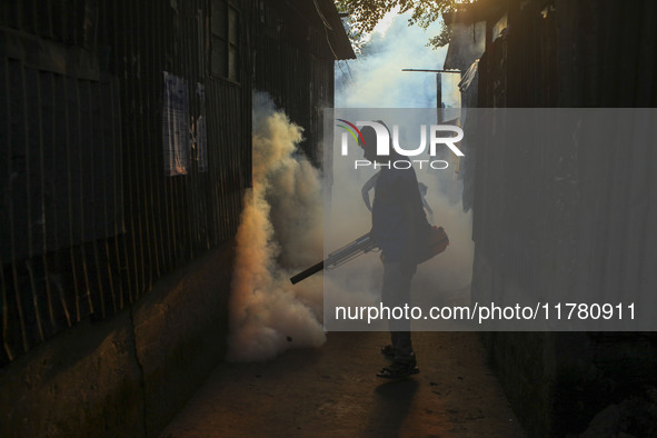 A worker sprays pesticide to kill mosquitoes at a slum in the capital city of Dhaka, Bangladesh. The country records 1,705 dengue-related de...