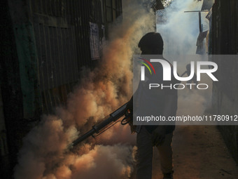 A worker sprays pesticide to kill mosquitoes at a slum in the capital city of Dhaka, Bangladesh. The country records 1,705 dengue-related de...