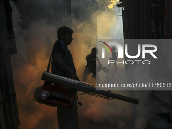 A worker sprays pesticide to kill mosquitoes at a slum in the capital city of Dhaka, Bangladesh. The country records 1,705 dengue-related de...