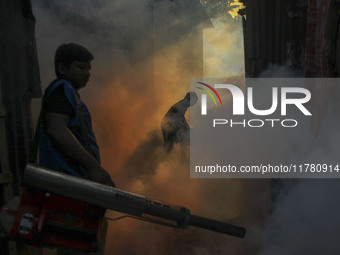 A worker sprays pesticide to kill mosquitoes at a slum in the capital city of Dhaka, Bangladesh. The country records 1,705 dengue-related de...