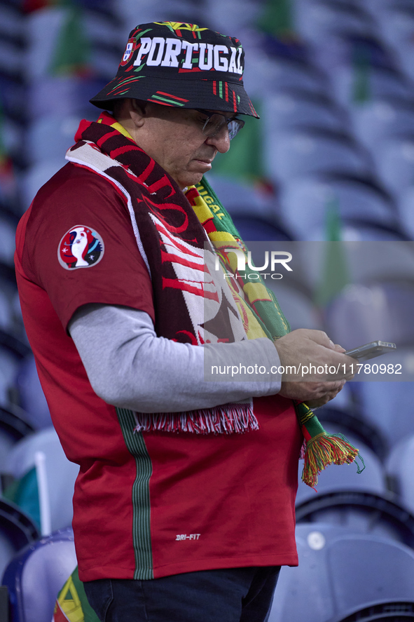 A Portugal fan waits for the start of the UEFA Nations League 2024/25 League A Group A1 match between Portugal and Poland at Estadio Do Drag...