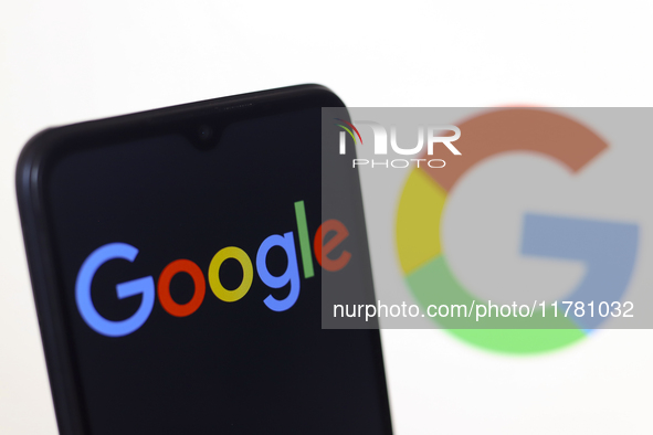 The Google logo appears on a smartphone screen and on the computer screen in the background in Reno, United States, on November 15, 2024. 