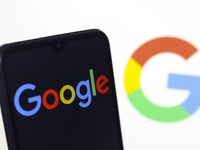 The Google logo appears on a smartphone screen and on the computer screen in the background in Reno, United States, on November 15, 2024. (