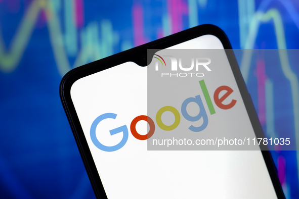 The Google logo appears on a smartphone screen, and in the background, a stock market graph is visible on the computer screen, in Reno, Unit...