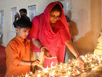 People light earthen lamps at the Shrine Galtaji temple holy pond 'kund' as part of the Deep Mahotsav celebration on the eve of Dev Deepawal...