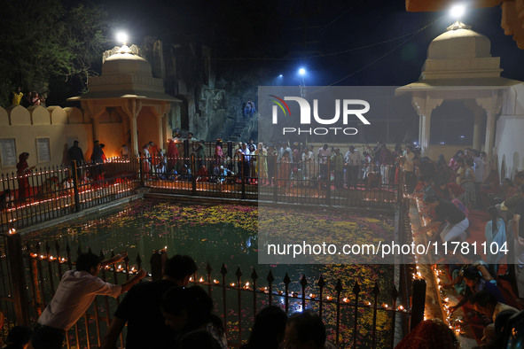 People light earthen lamps at the Shrine Galtaji temple holy pond 'kund' as part of the Deep Mahotsav celebration on the eve of Dev Deepawal...