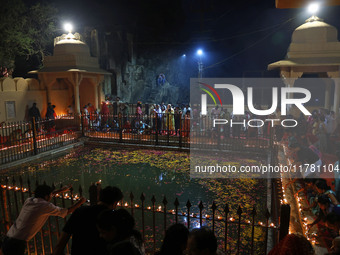 People light earthen lamps at the Shrine Galtaji temple holy pond 'kund' as part of the Deep Mahotsav celebration on the eve of Dev Deepawal...