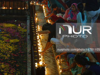 People light earthen lamps at the Shrine Galtaji temple holy pond 'kund' as part of the Deep Mahotsav celebration on the eve of Dev Deepawal...