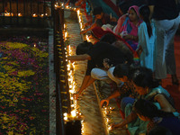 People light earthen lamps at the Shrine Galtaji temple holy pond 'kund' as part of the Deep Mahotsav celebration on the eve of Dev Deepawal...