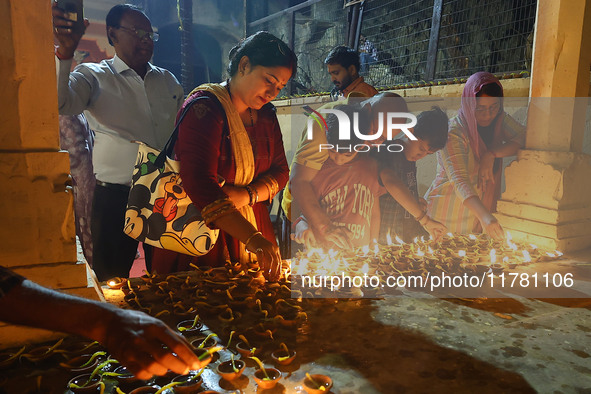 People light earthen lamps at the Shrine Galtaji temple holy pond 'kund' as part of the Deep Mahotsav celebration on the eve of Dev Deepawal...