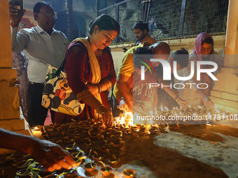 People light earthen lamps at the Shrine Galtaji temple holy pond 'kund' as part of the Deep Mahotsav celebration on the eve of Dev Deepawal...