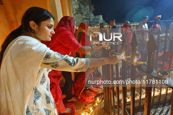 People light earthen lamps at the Shrine Galtaji temple holy pond 'kund' as part of the Deep Mahotsav celebration on the eve of Dev Deepawal...