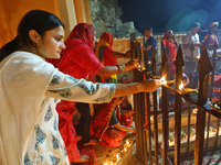 People light earthen lamps at the Shrine Galtaji temple holy pond 'kund' as part of the Deep Mahotsav celebration on the eve of Dev Deepawal...