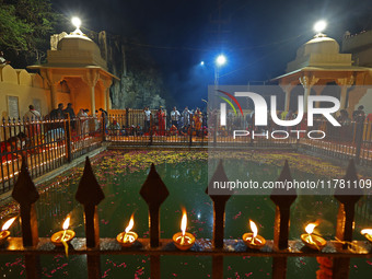 People light earthen lamps at the Shrine Galtaji temple holy pond 'kund' as part of the Deep Mahotsav celebration on the eve of Dev Deepawal...