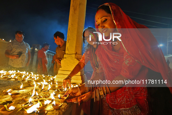 People light earthen lamps at the Shrine Galtaji temple holy pond 'kund' as part of the Deep Mahotsav celebration on the eve of Dev Deepawal...