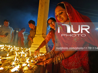 People light earthen lamps at the Shrine Galtaji temple holy pond 'kund' as part of the Deep Mahotsav celebration on the eve of Dev Deepawal...