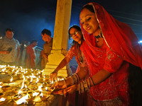 People light earthen lamps at the Shrine Galtaji temple holy pond 'kund' as part of the Deep Mahotsav celebration on the eve of Dev Deepawal...