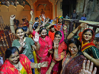 In Jaipur, Rajasthan, India, on November 15, 2024, people dance after lighting earthen lamps at the Shrine Galtaji temple holy pond 'kund' a...