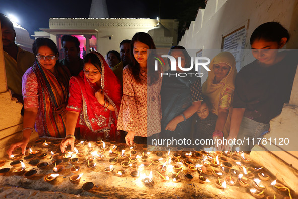 JMC Heritage Mayor Kusum Yadav and people light earthen lamps at the Shrine Galtaji temple holy pond 'kund' as part of the Deep Mahotsav cel...