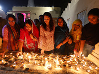 JMC Heritage Mayor Kusum Yadav and people light earthen lamps at the Shrine Galtaji temple holy pond 'kund' as part of the Deep Mahotsav cel...