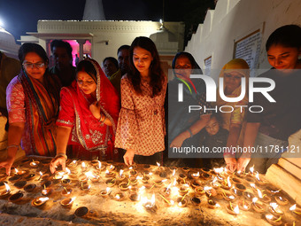 In Jaipur, Rajasthan, India, on November 15, 2024, JMC Heritage Mayor Kusum Yadav and people light earthen lamps at the Shrine Galtaji templ...