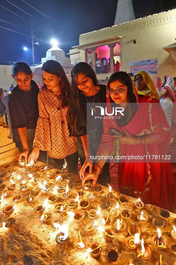 People light earthen lamps at the Shrine Galtaji temple holy pond 'kund' as part of the Deep Mahotsav celebration on the eve of Dev Deepawal...