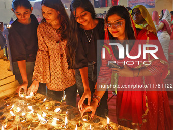 People light earthen lamps at the Shrine Galtaji temple holy pond 'kund' as part of the Deep Mahotsav celebration on the eve of Dev Deepawal...