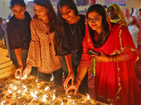 People light earthen lamps at the Shrine Galtaji temple holy pond 'kund' as part of the Deep Mahotsav celebration on the eve of Dev Deepawal...