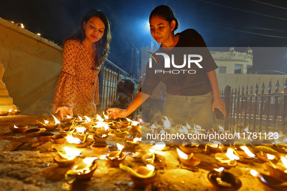 People light earthen lamps at the Shrine Galtaji temple holy pond 'kund' as part of the Deep Mahotsav celebration on the eve of Dev Deepawal...