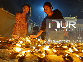 People light earthen lamps at the Shrine Galtaji temple holy pond 'kund' as part of the Deep Mahotsav celebration on the eve of Dev Deepawal...