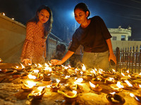 People light earthen lamps at the Shrine Galtaji temple holy pond 'kund' as part of the Deep Mahotsav celebration on the eve of Dev Deepawal...