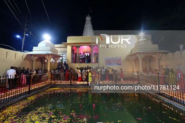 People light earthen lamps at the Shrine Galtaji temple holy pond 'kund' as part of the Deep Mahotsav celebration on the eve of Dev Deepawal...