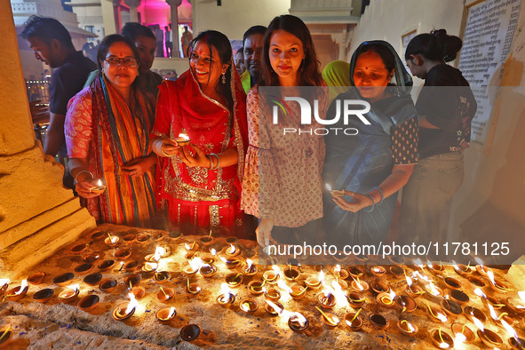 JMC Heritage Mayor Kusum Yadav and people light earthen lamps at the Shrine Galtaji temple holy pond 'kund' as part of the Deep Mahotsav cel...