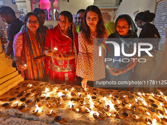 JMC Heritage Mayor Kusum Yadav and people light earthen lamps at the Shrine Galtaji temple holy pond 'kund' as part of the Deep Mahotsav cel...