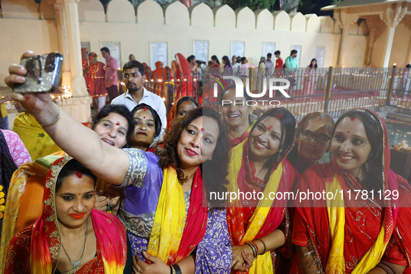 JMC Heritage Mayor Kusum Yadav poses with people after lighting earthen lamps at the Shrine Galtaji temple holy pond 'kund' as part of the D...