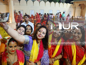 JMC Heritage Mayor Kusum Yadav poses with people after lighting earthen lamps at the Shrine Galtaji temple holy pond 'kund' as part of the D...