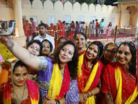 JMC Heritage Mayor Kusum Yadav poses with people after lighting earthen lamps at the Shrine Galtaji temple holy pond 'kund' as part of the D...