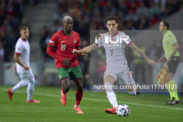 Kacper Urbanski of Poland is challenged by Nuno Mendes of Portugal during the UEFA Nations League 2024/25 League A Group A1 match between Po...