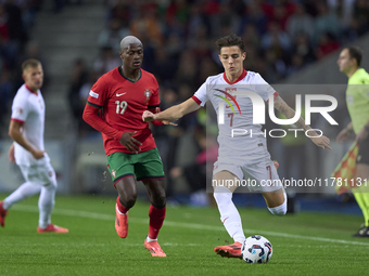 Kacper Urbanski of Poland is challenged by Nuno Mendes of Portugal during the UEFA Nations League 2024/25 League A Group A1 match between Po...