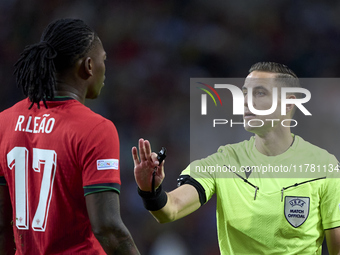 Referee Donatas Rumsas and Rafael Leao of Portugal discuss during the UEFA Nations League 2024/25 League A Group A1 match between Portugal a...