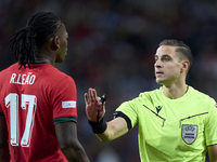 Referee Donatas Rumsas and Rafael Leao of Portugal discuss during the UEFA Nations League 2024/25 League A Group A1 match between Portugal a...