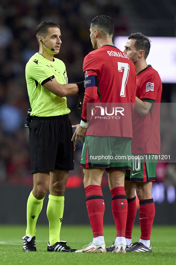 Referee Donatas Rumsas, Cristiano Ronaldo, and Bernardo Silva of Portugal discuss during the UEFA Nations League 2024/25 League A Group A1 m...