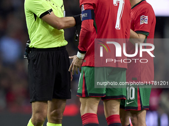 Referee Donatas Rumsas, Cristiano Ronaldo, and Bernardo Silva of Portugal discuss during the UEFA Nations League 2024/25 League A Group A1 m...