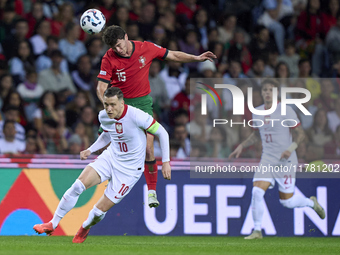 Joao Neves of Portugal competes for the ball with Piotr Zielinski of Poland during the UEFA Nations League 2024/25 League A Group A1 match b...