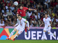 Joao Neves of Portugal competes for the ball with Piotr Zielinski of Poland during the UEFA Nations League 2024/25 League A Group A1 match b...