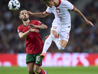 Bernardo Silva of Portugal competes for the ball with Kacper Urbanski of Poland during the UEFA Nations League 2024/25 League A Group A1 mat...